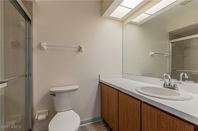 bathroom with walk in shower, vanity, and toilet