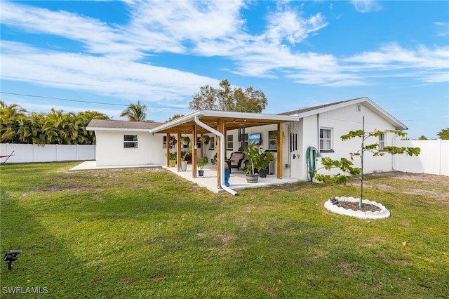 back of property featuring a yard and a patio area