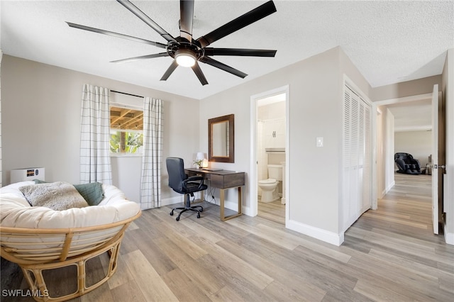 office with ceiling fan, a textured ceiling, and light hardwood / wood-style floors