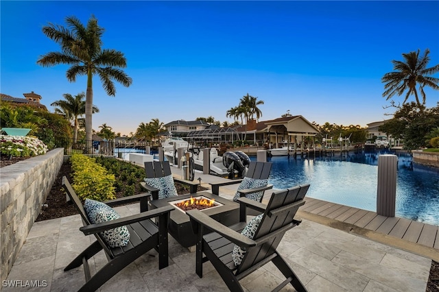 exterior space featuring a fire pit and a water view