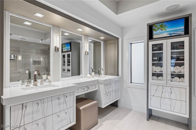 bathroom with a wealth of natural light, vanity, and an enclosed shower