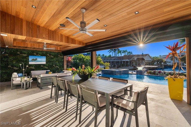 view of patio / terrace featuring a swimming pool with hot tub, an outdoor living space, and ceiling fan