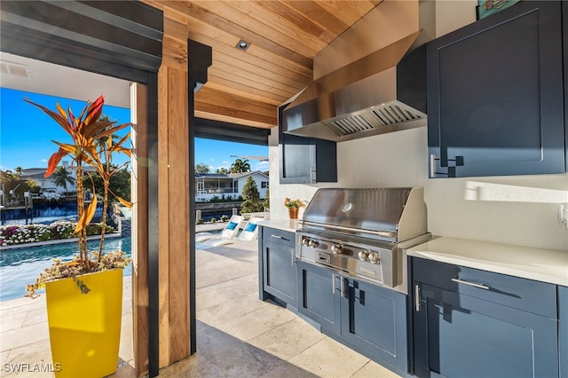 view of patio / terrace with area for grilling, exterior kitchen, and a swimming pool