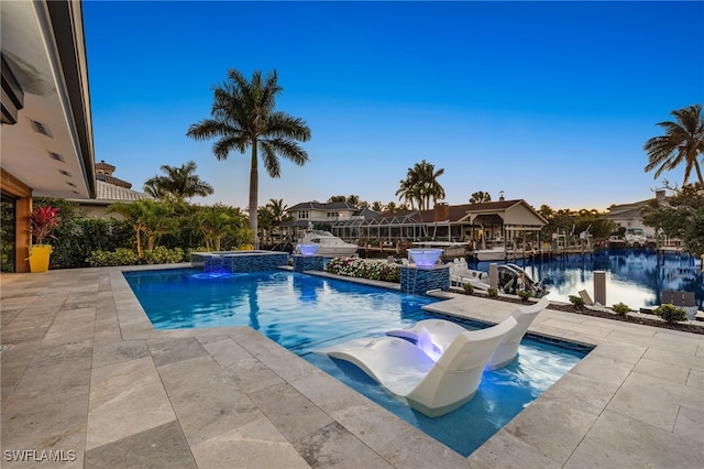 view of swimming pool with pool water feature, a jacuzzi, and a patio