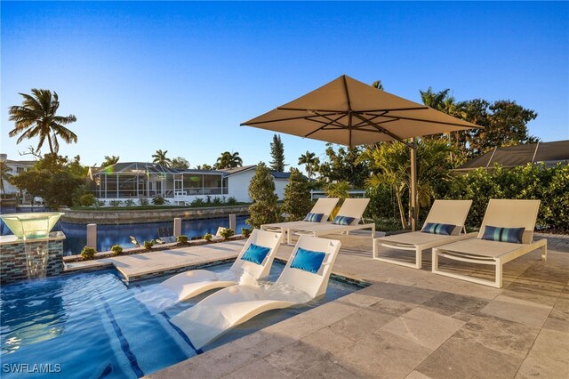 view of pool with pool water feature and a patio