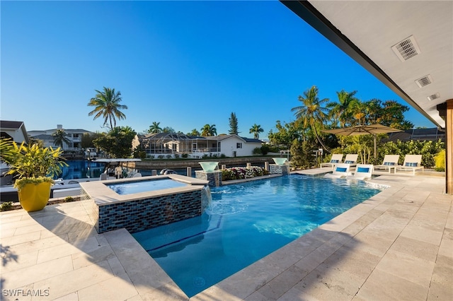 view of pool featuring a patio area, an in ground hot tub, and pool water feature