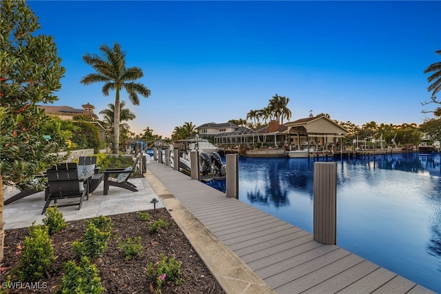 dock area with a water view and a patio area