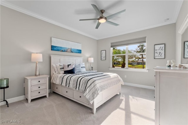 bedroom featuring ceiling fan, light colored carpet, and crown molding