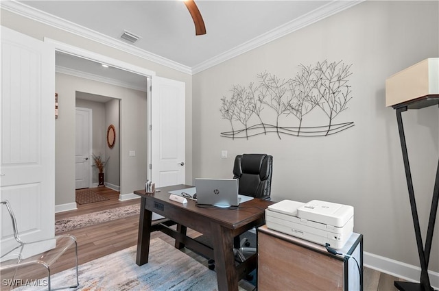 office featuring hardwood / wood-style floors, ceiling fan, and ornamental molding