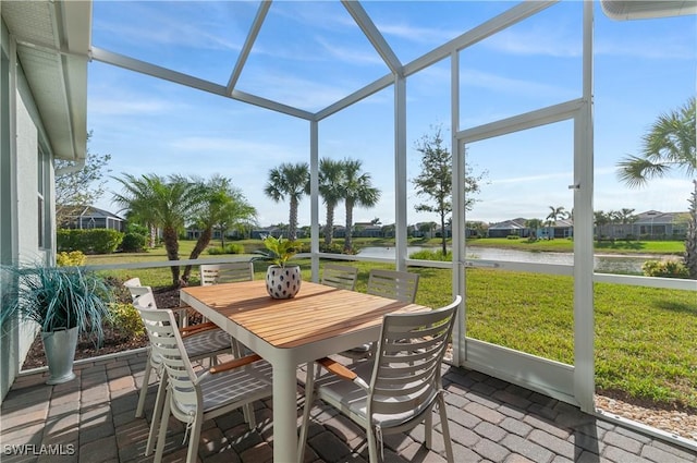 sunroom / solarium with a water view