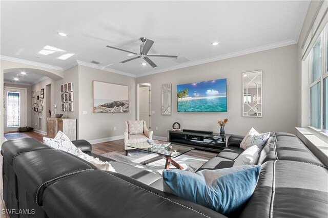 living room with ceiling fan, wood-type flooring, and ornamental molding