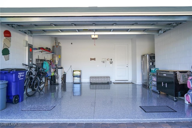 garage with stainless steel fridge, electric panel, gas water heater, and a garage door opener