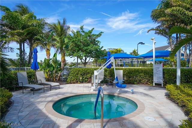 view of swimming pool with a patio area and a community hot tub