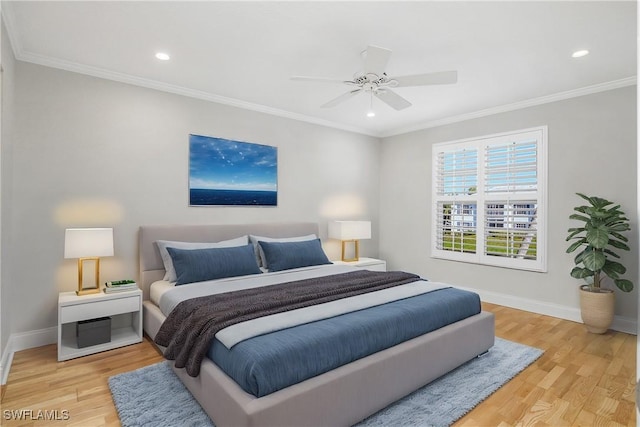 bedroom featuring ceiling fan, crown molding, and wood-type flooring