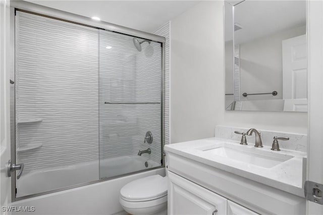 full bathroom with vanity, enclosed tub / shower combo, and toilet