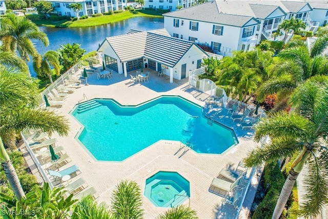 view of swimming pool with a water view and a patio