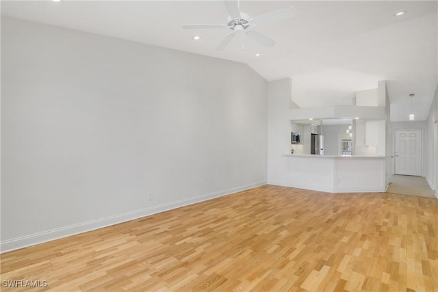 unfurnished living room with light wood-type flooring, ceiling fan, and lofted ceiling