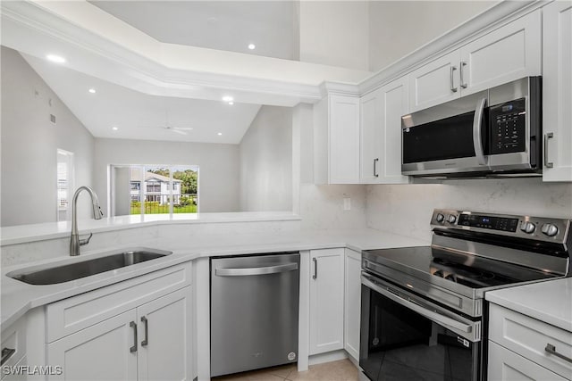 kitchen featuring white cabinetry, sink, ceiling fan, stainless steel appliances, and light tile patterned floors