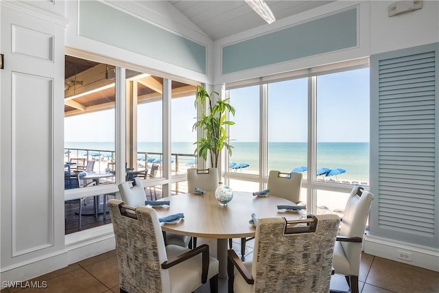 sunroom with a beach view and a water view