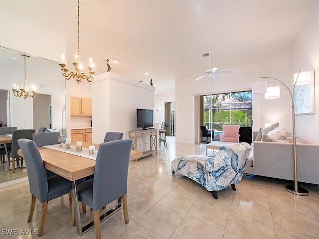 dining space with a high ceiling and ceiling fan with notable chandelier