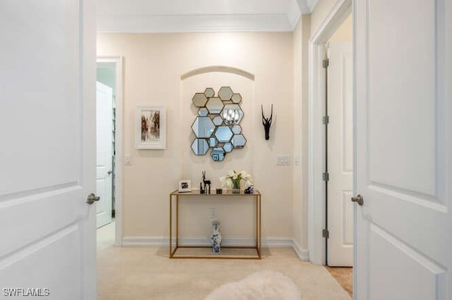hallway with baseboards and ornamental molding