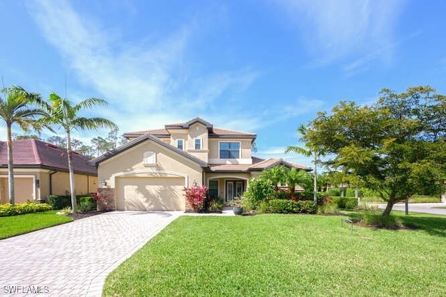 view of front of home with a garage, a front lawn, decorative driveway, and stucco siding