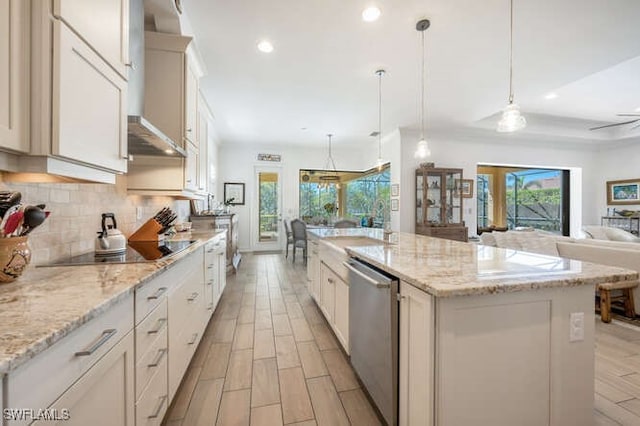 kitchen with backsplash, plenty of natural light, black electric cooktop, and stainless steel dishwasher