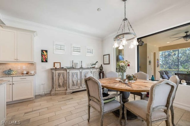 dining area featuring ornamental molding, baseboards, and a ceiling fan