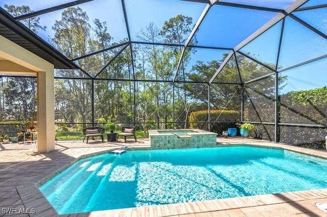 view of swimming pool featuring a lanai, a patio area, and a pool with connected hot tub