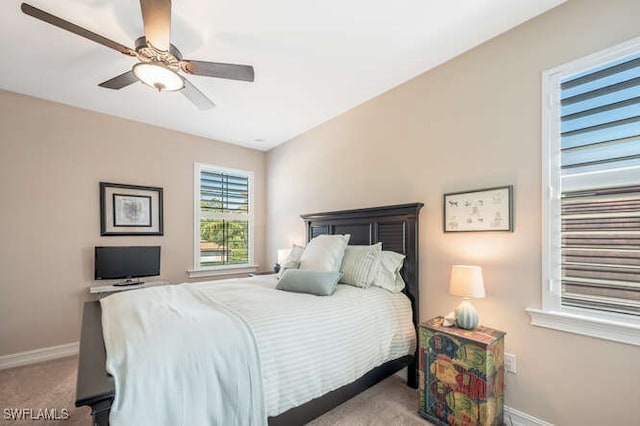 carpeted bedroom featuring ceiling fan and baseboards
