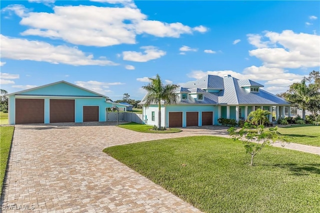 view of front of home featuring a garage and a front lawn