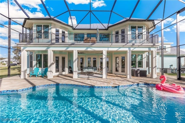 rear view of house featuring french doors, a patio, a balcony, and a lanai