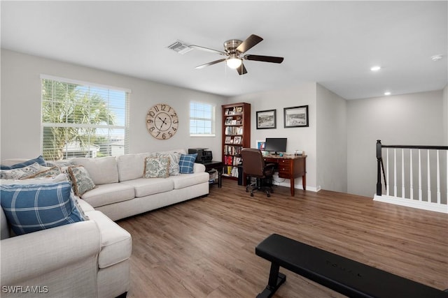 living room with hardwood / wood-style flooring and ceiling fan