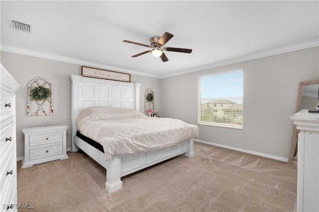 carpeted bedroom with ceiling fan and crown molding