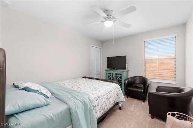 carpeted bedroom with a closet and ceiling fan