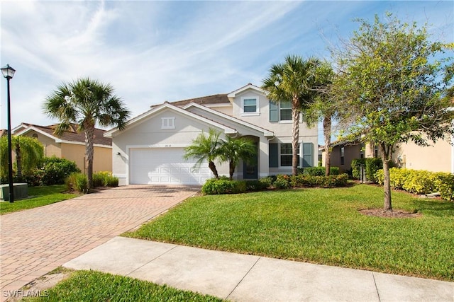 view of front of house with central AC, a front lawn, and a garage