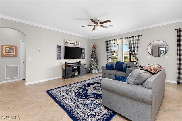 tiled living room with ceiling fan and crown molding