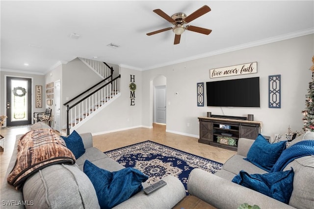 tiled living room featuring ceiling fan and crown molding