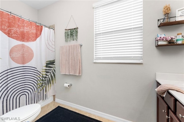 bathroom with tile patterned flooring, vanity, and toilet