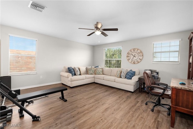 home office with hardwood / wood-style floors and ceiling fan