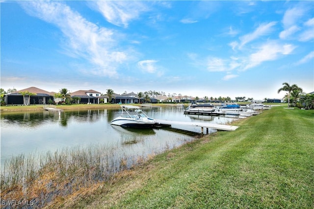 view of dock with a yard and a water view