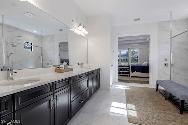 bathroom featuring tiled shower and vanity