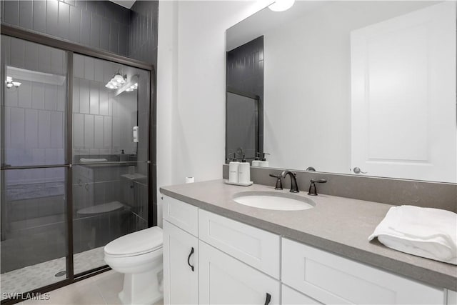 bathroom featuring vanity, toilet, tile patterned floors, and a shower with door