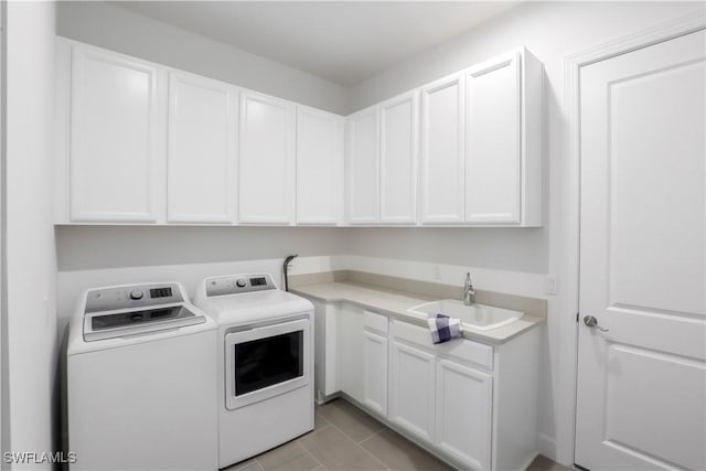 clothes washing area featuring cabinets, separate washer and dryer, light tile patterned floors, and sink