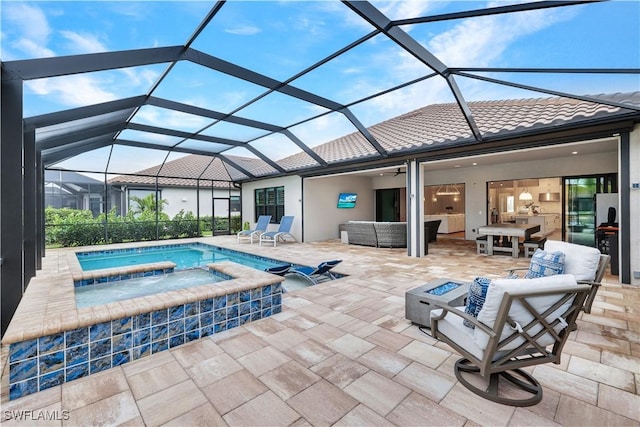 view of pool with a lanai, an outdoor hangout area, an in ground hot tub, and a patio