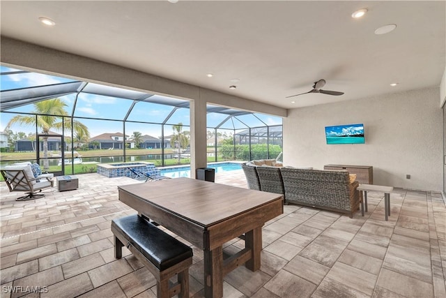 view of patio / terrace featuring glass enclosure, outdoor lounge area, and ceiling fan