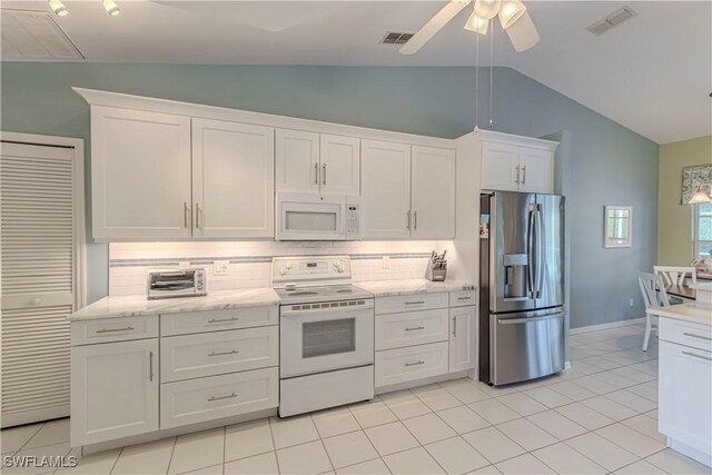 kitchen with white appliances, white cabinetry, tasteful backsplash, vaulted ceiling, and ceiling fan