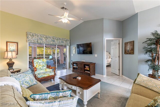 living room with ceiling fan, light tile patterned floors, and lofted ceiling