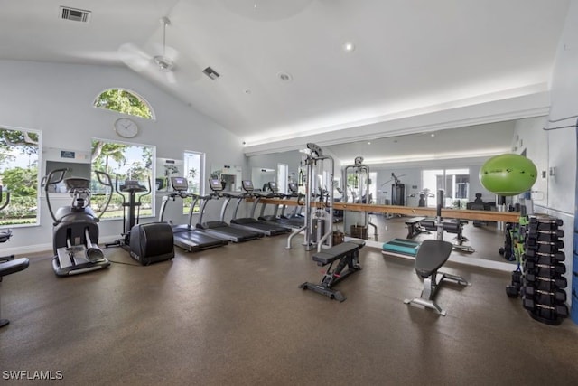 gym with ceiling fan, a wealth of natural light, and high vaulted ceiling