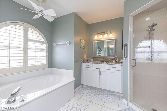 bathroom featuring plus walk in shower, ceiling fan, tile patterned flooring, and vanity